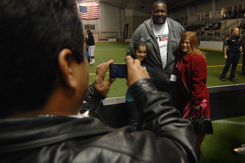 Actor Quinton Aaron is photographed by J.R. Rivera with Elizabeth Rivera, 12, and her mother...