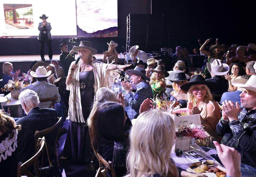 Letitia Frye, aka the "auction-tainer," congratulates a winning bidder at the Cattle Baron's...