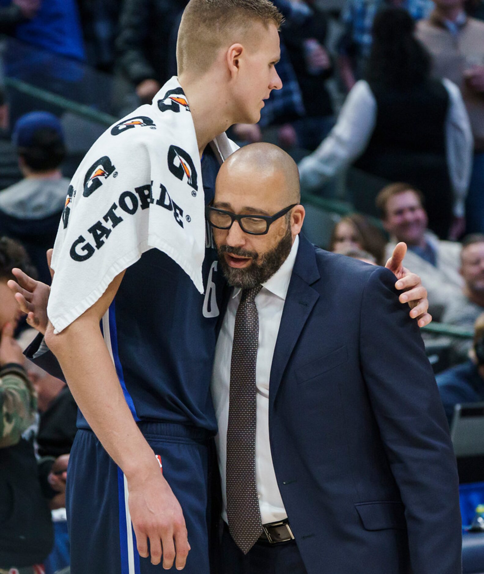 Dallas Mavericks forward Kristaps Porzingis hugs New York Knicks head coach David Fizdale...