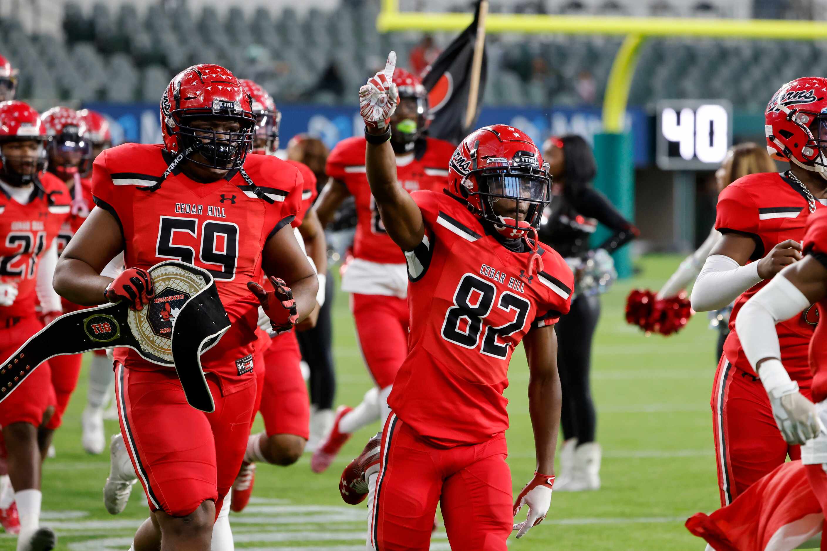 Cedar Hill’s Kason Anderson (59) and Jaylen Robinson (82) enter the field prior to playing...