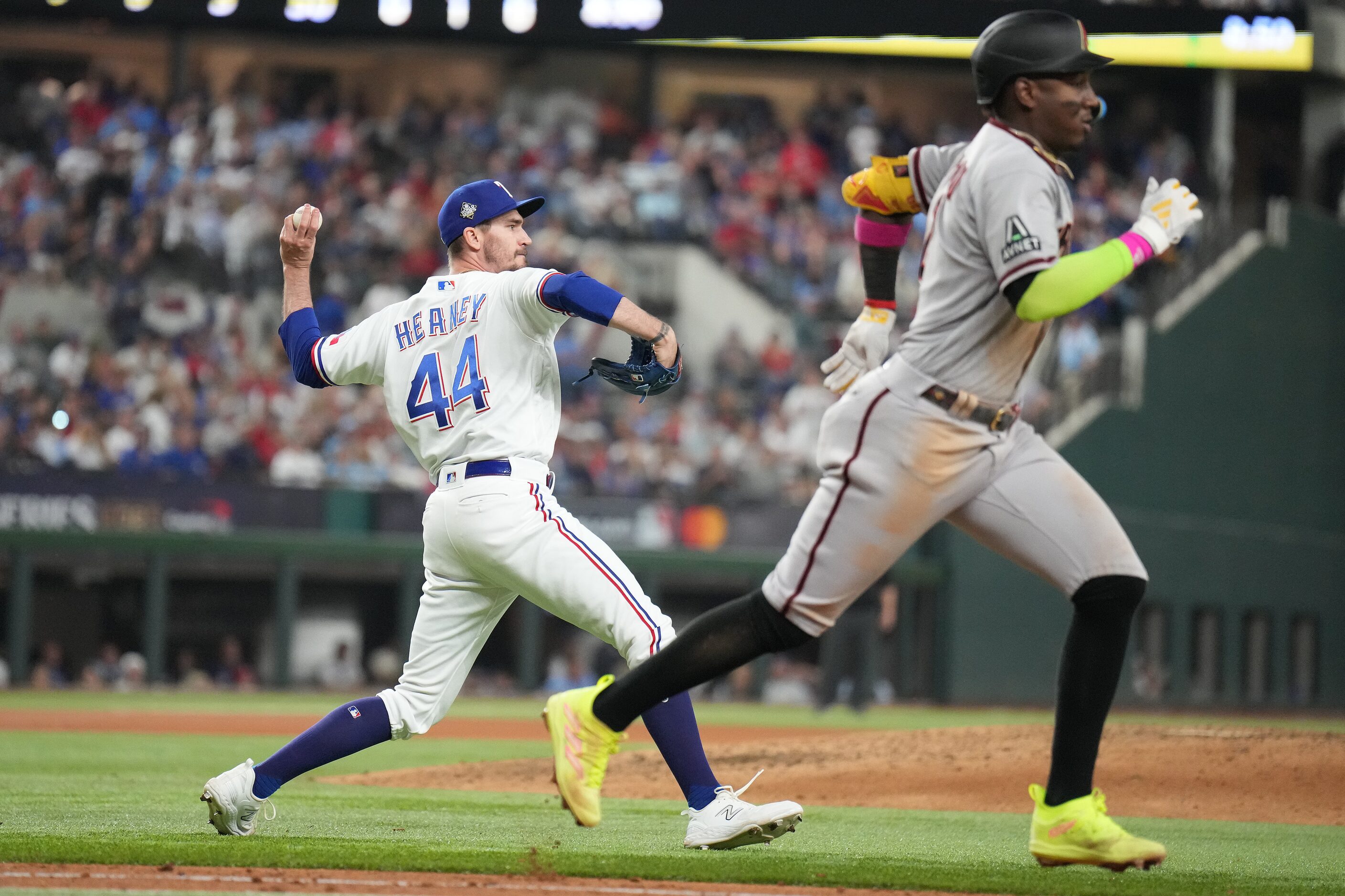 Texas Rangers pitcher Andrew Heaney throws out Arizona Diamondbacks' Geraldo Perdomo on a...