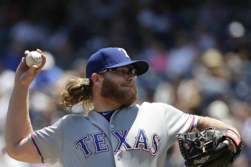 Texas Rangers' A.J. Griffin delivers a pitch during the first inning of a baseball game...