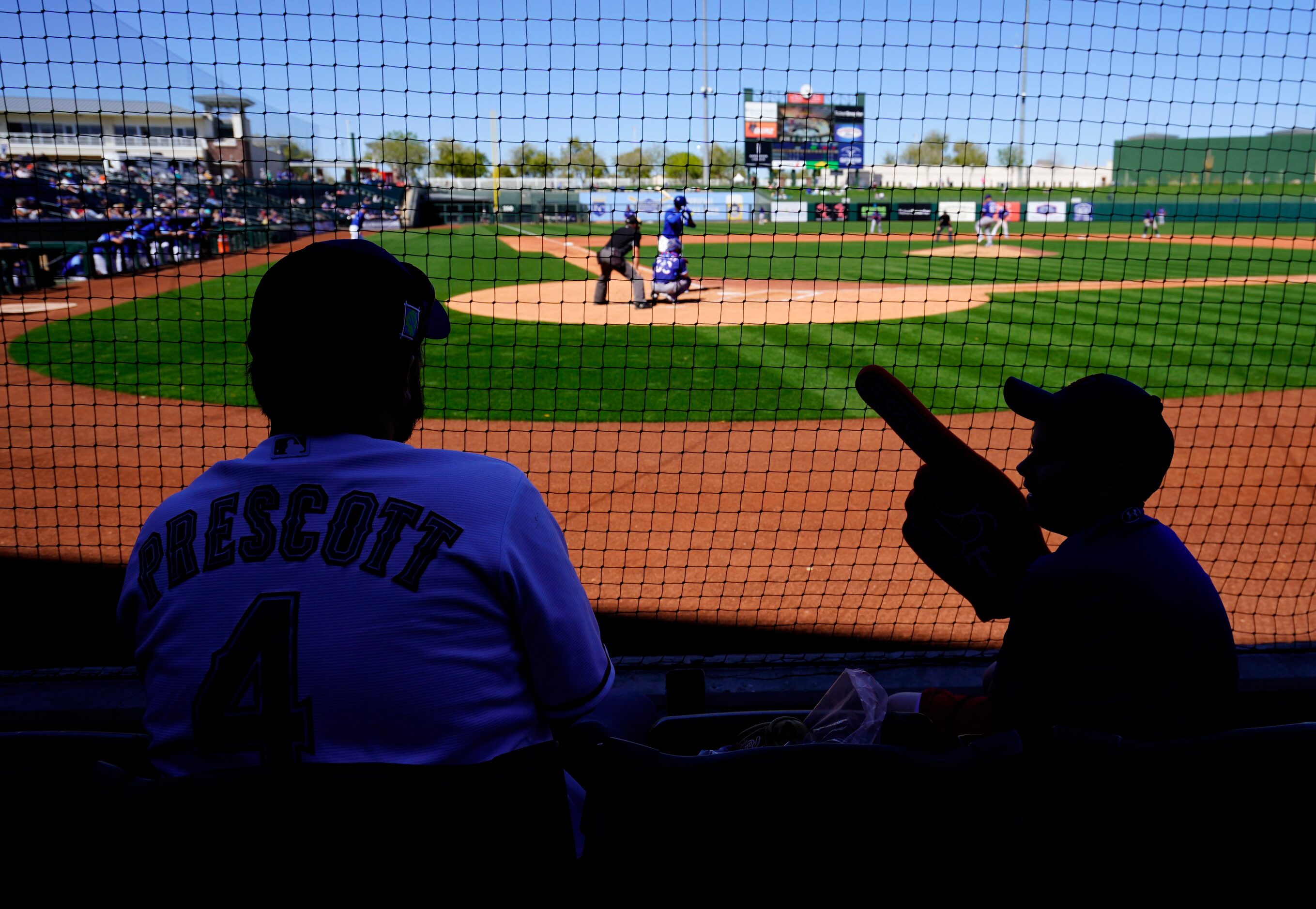 Texas Rangers’ fans Micael Dickerson (originally from Merkel TX) talks to his son Landry 10,...