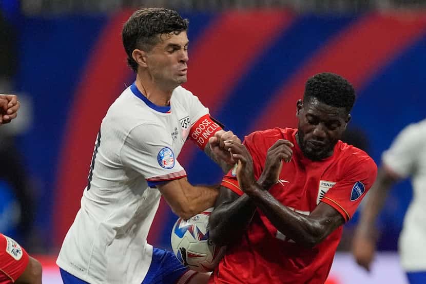 Panama's Jose Fajardo, front, and Christian Pulisic of the United States battle for the ball...