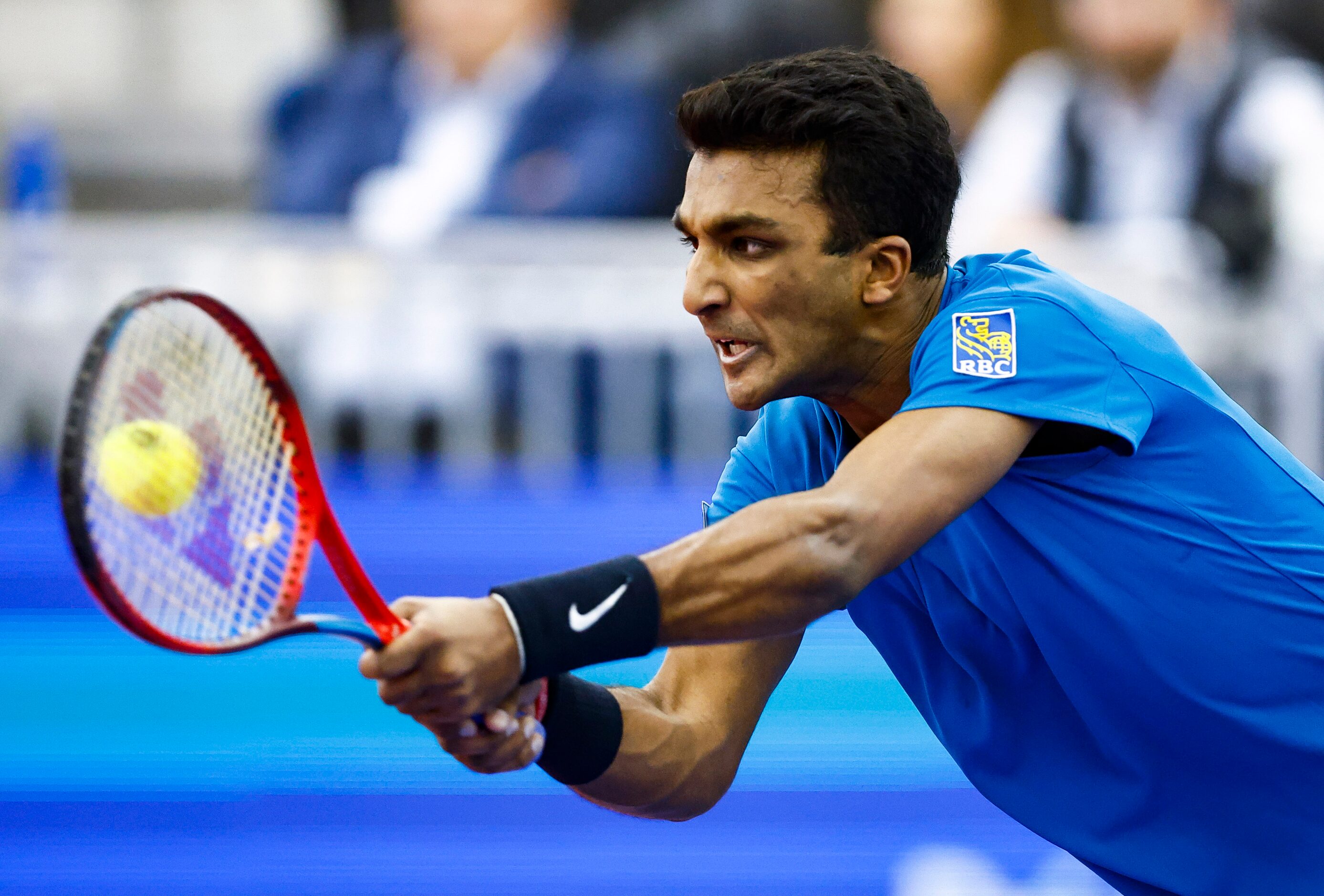 SMU senior Caleb Chakravarthi returns the ball in a match against Vasek Pospisil during the...