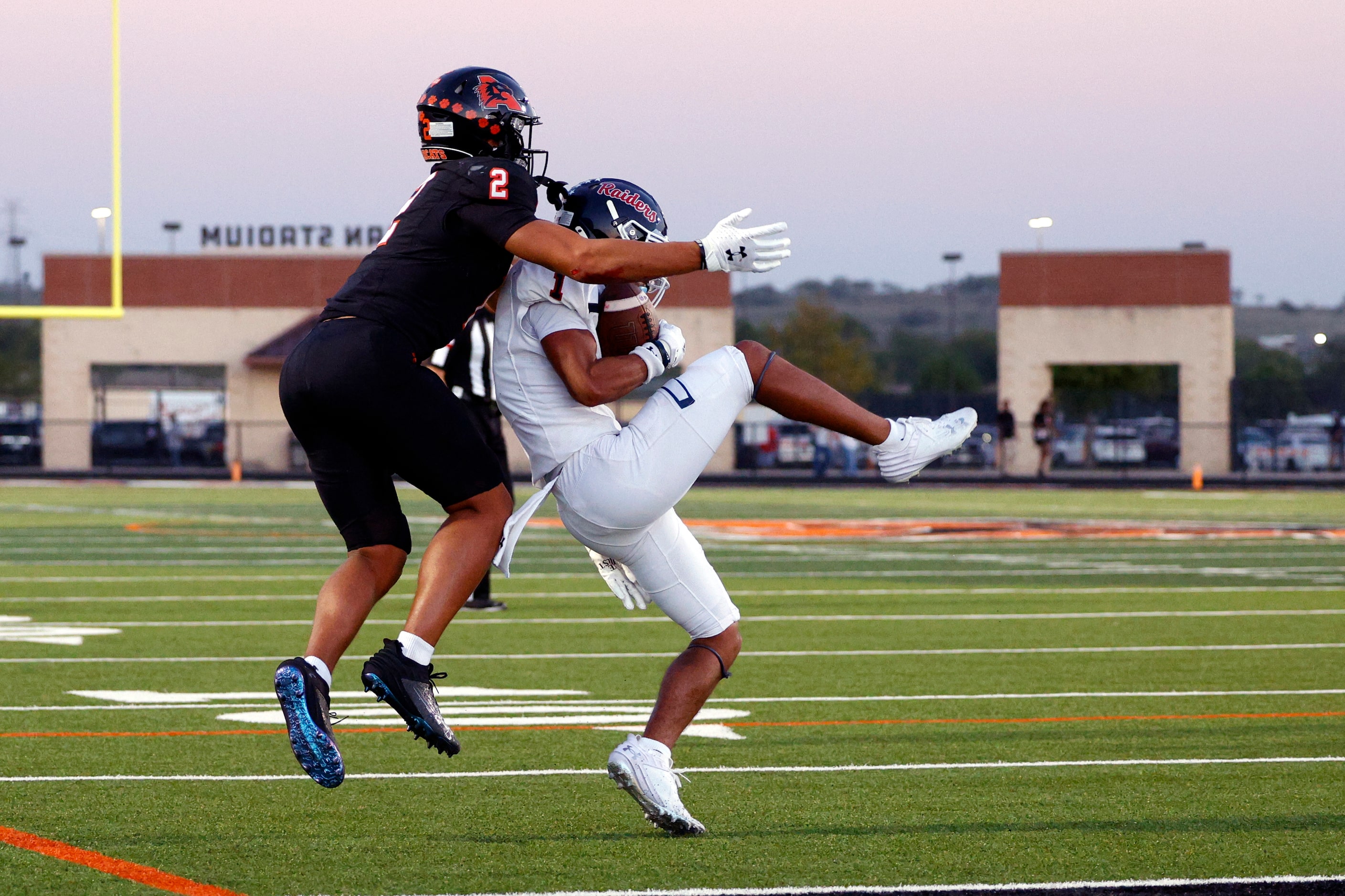 Denton Ryan defensive back Trae Williams (1) intercepts a pass intended for Aledo wide...