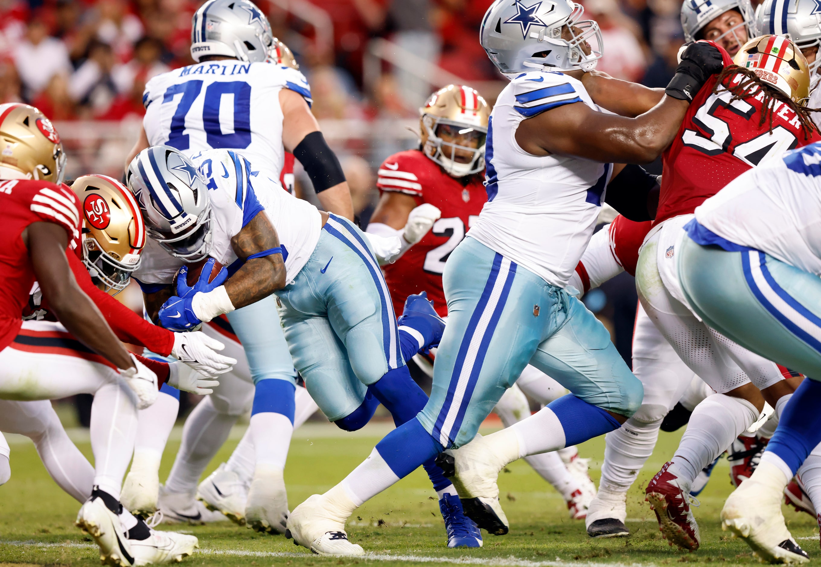 Dallas Cowboys running back Ezekiel Elliott (15) plows his way through the line to score a...