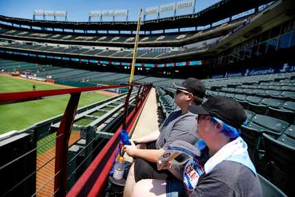 Texas Rangers fans Paige Baucom (front) and Patrick Rovell of Lone Oak try to keep cool...