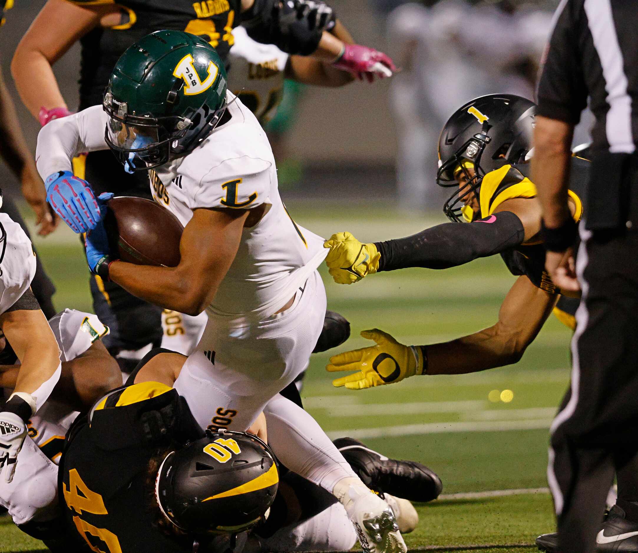 Longview's Taylor Tatum (2), left, carries the ball as Forney's Aaron Flowers (1), right,...
