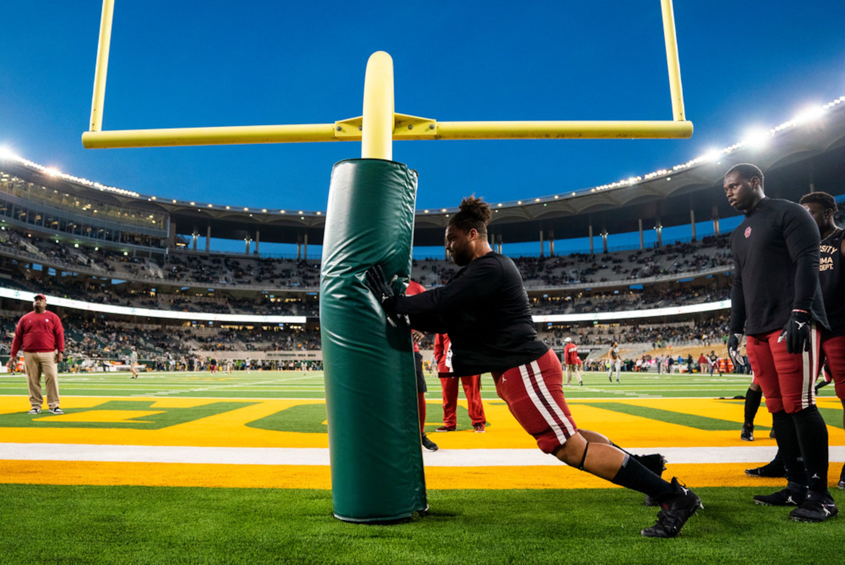 Oklahoma Sooners defensive players warm up before an NCAA football game between Baylor...