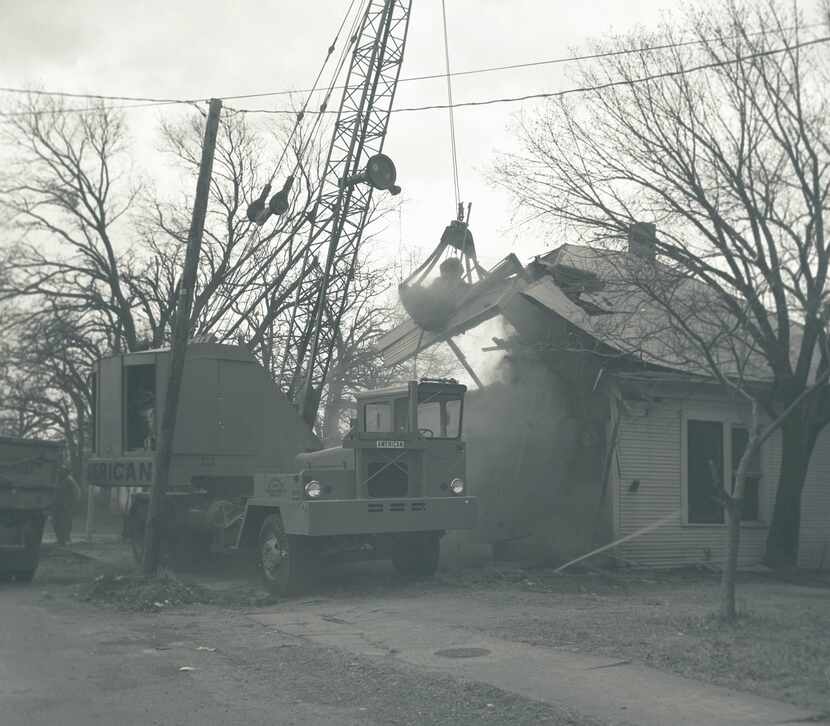 A wrecking crew goes to work demolishing a Fair Park house in the 1960s, to make way for a...