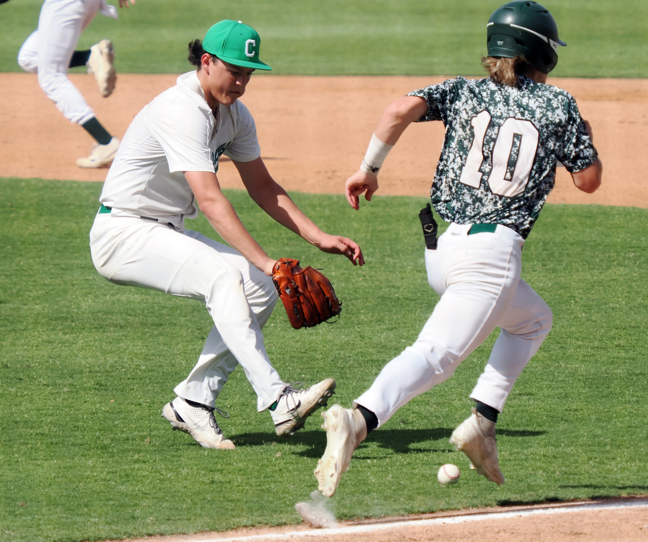 Southlake Carroll pitcher Owen Proksch (9) chases down a ball  bunted by San Antonio Reagan...