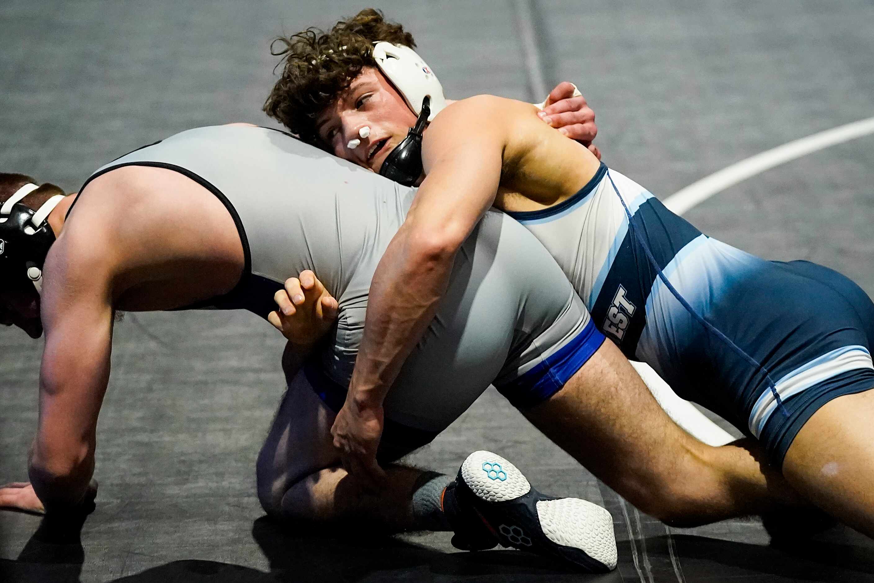 Tagen Jamison of Plano West wrestles Mason Woodward of Weatherford for the 6A boys 138-pound...