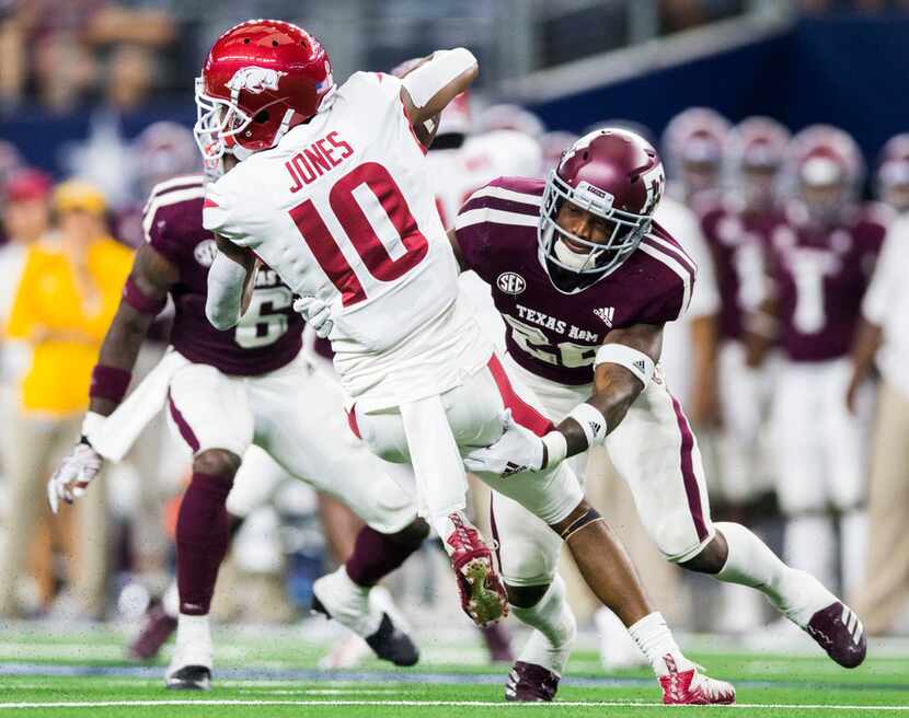 Texas A&M Aggies defensive back Deshawn Capers-Smith (26) tackles Arkansas Razorbacks wide...