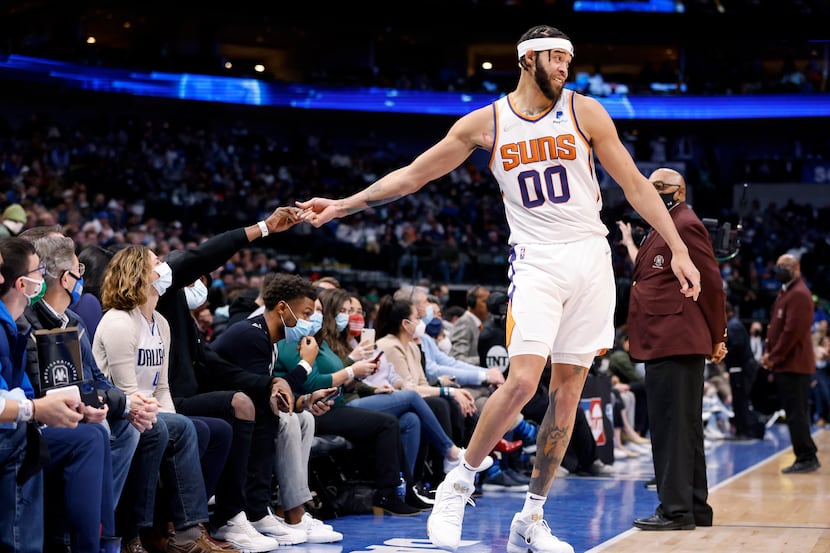 Phoenix Suns center JaVale McGee (00) shakes hands with fans on the sideline during a first...