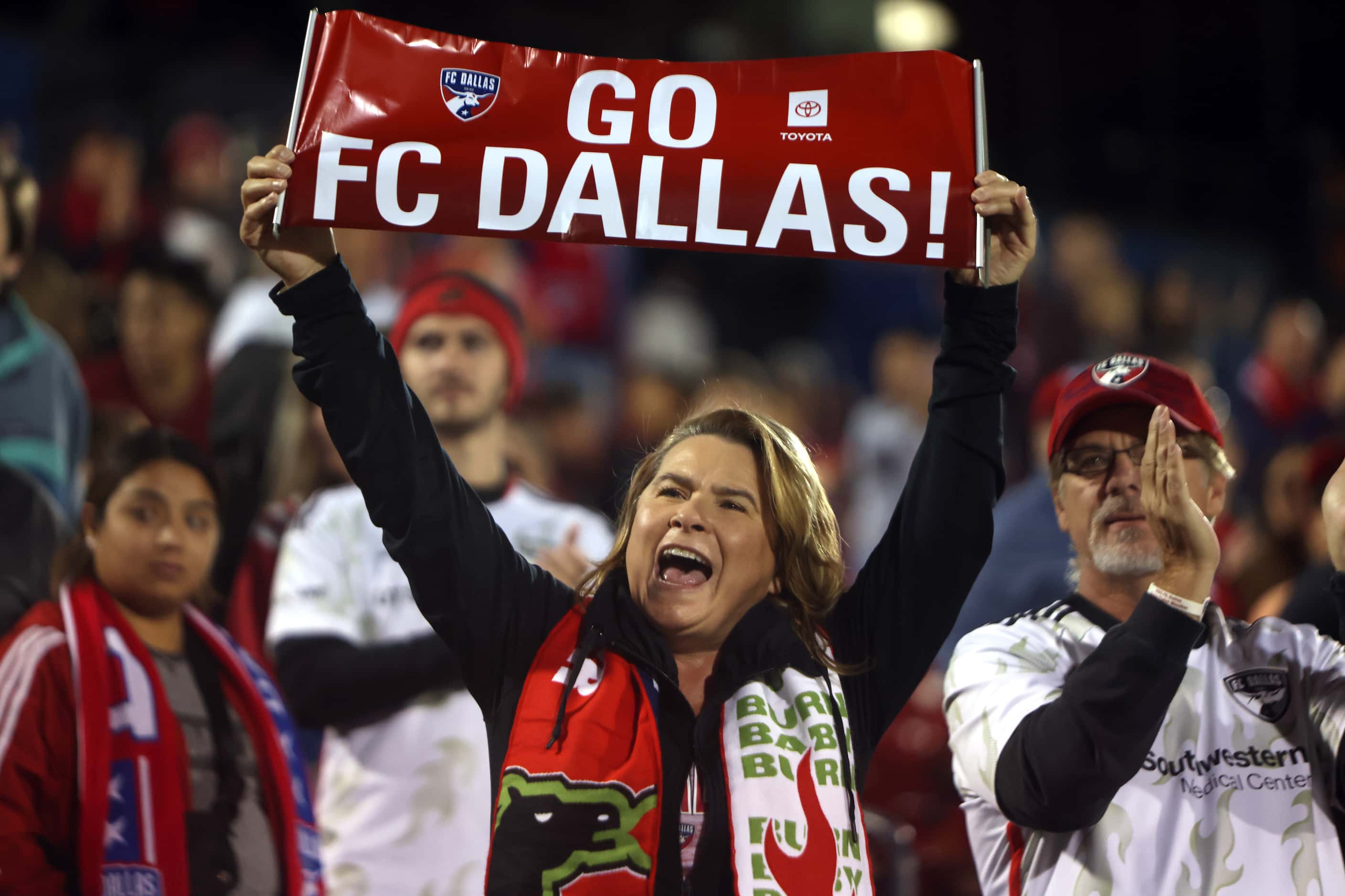 FC Dallas fans cheer as team members come out onto the field prior to the start of their...