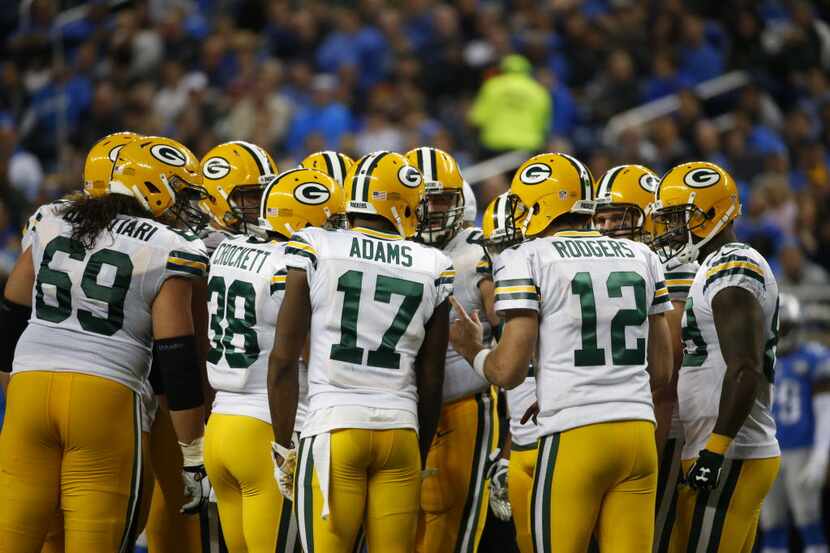 Green Bay Packers quarterback Aaron Rodgers (12) huddles the offense against the Detroit...