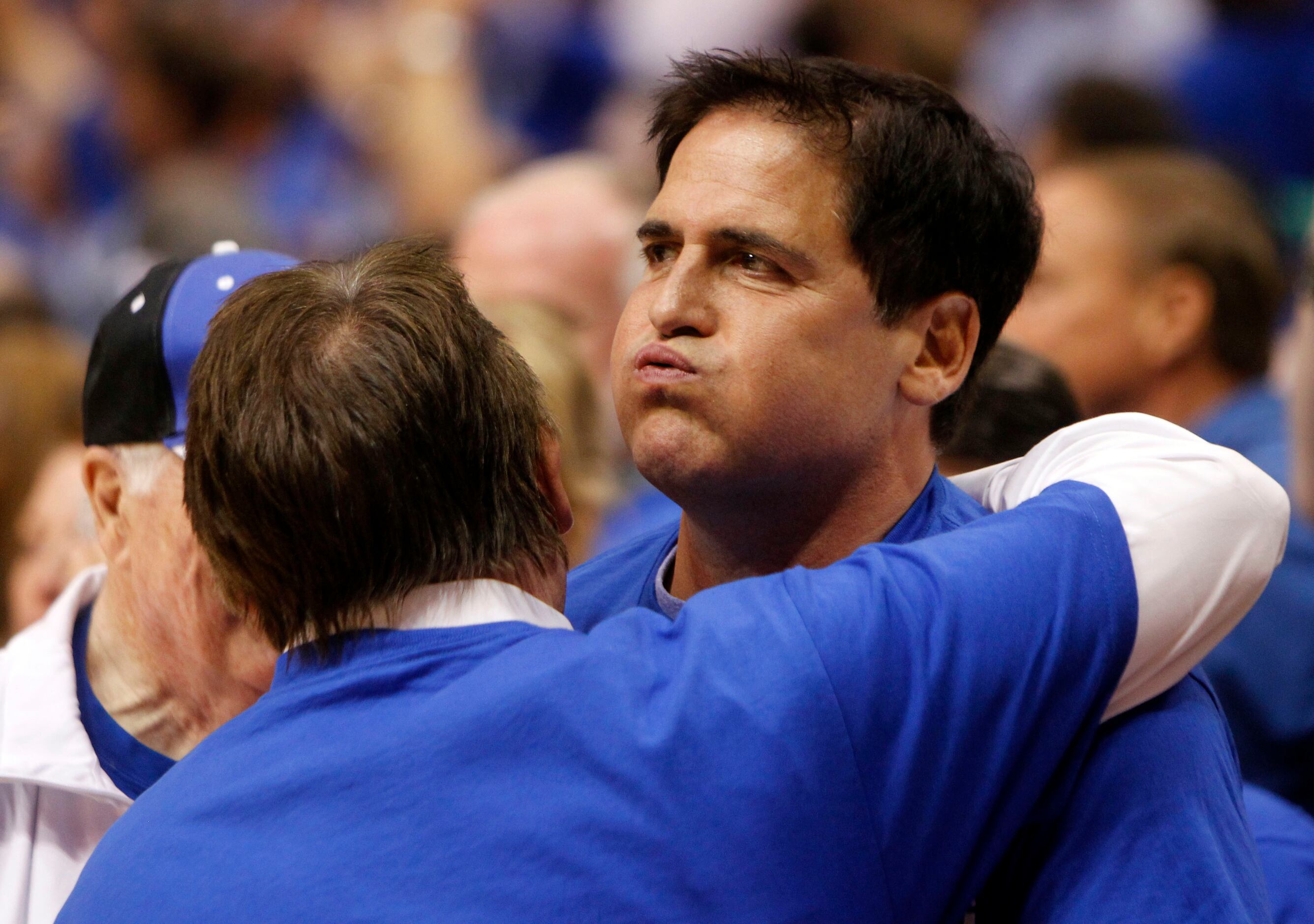 June 9, 2011: Mark Cuban blows out a sigh of relief as he celebrates with fans after...