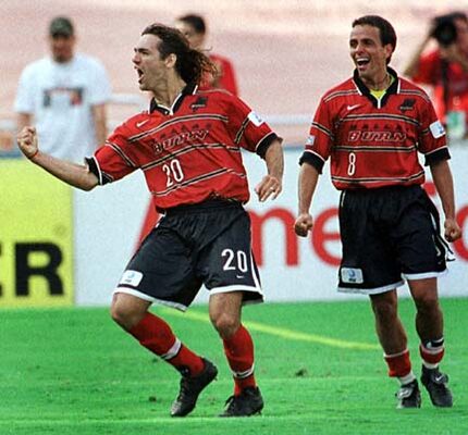 Ariel Graziani of the Dallas Burn celebrates as Oscar Pareja looks on.