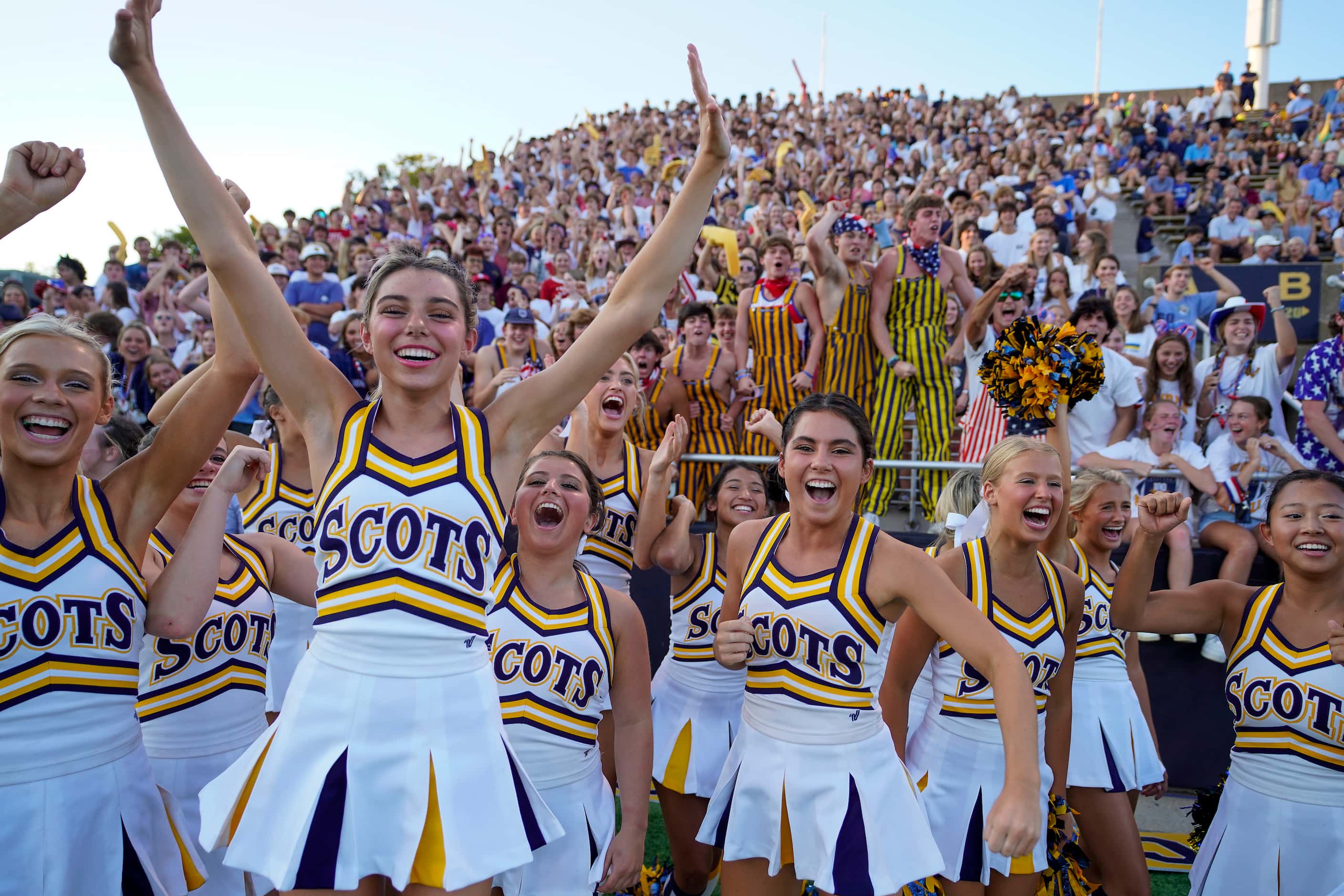 Highland Park cheerleaders and crowd cheer before the opening kickoff a high school football...