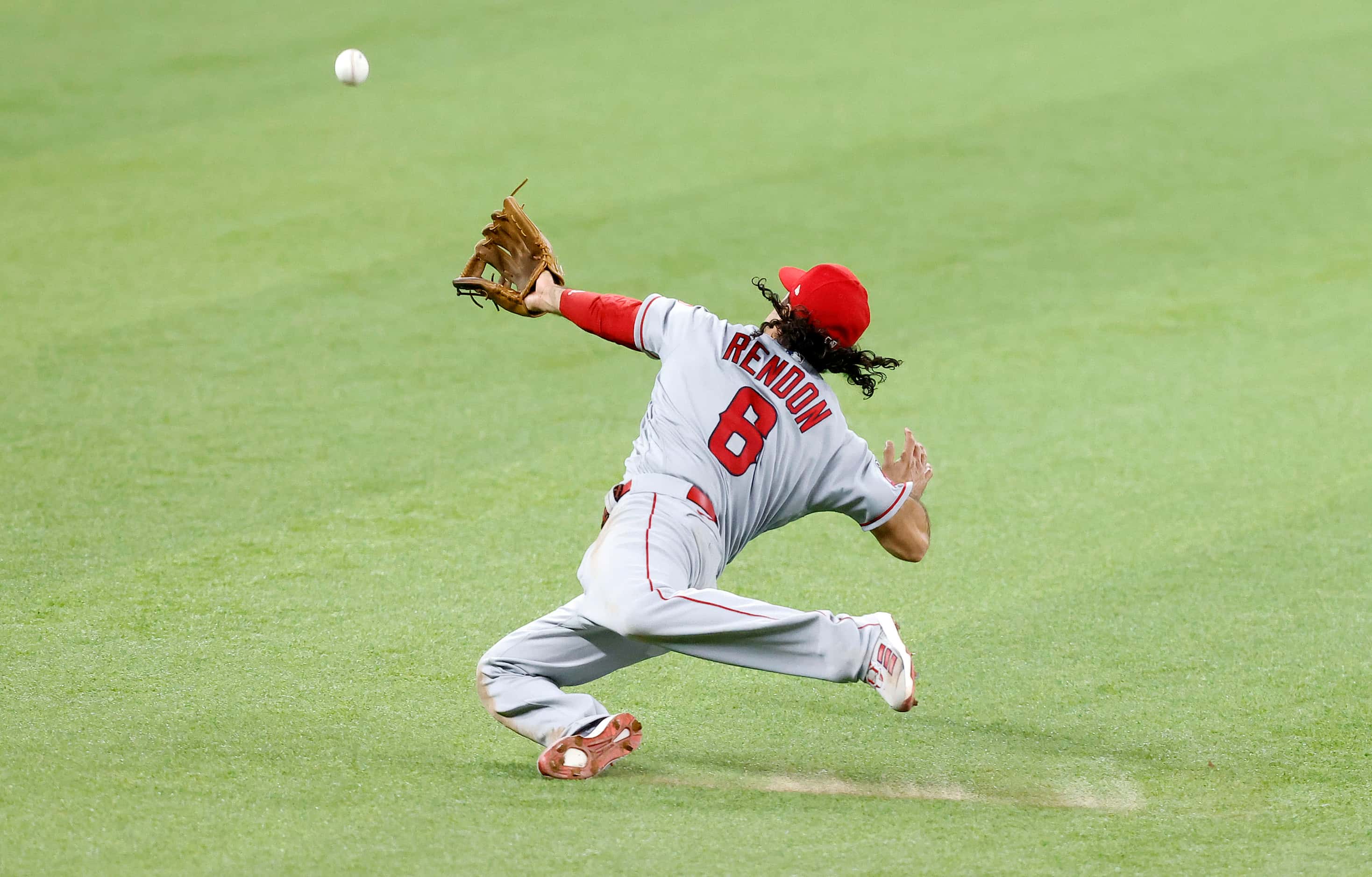 Los Angeles Angels third baseman Anthony Rendon (6) dives for a fly ball hit by Texas...