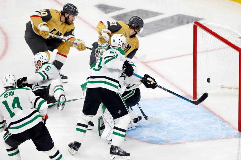 Vegas Golden Knights center Chandler Stephenson (20) scores on Dallas Stars goaltender Jake...