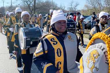 South Oak Cliff High School band members line the streets as Dallas celebrates the campus'...