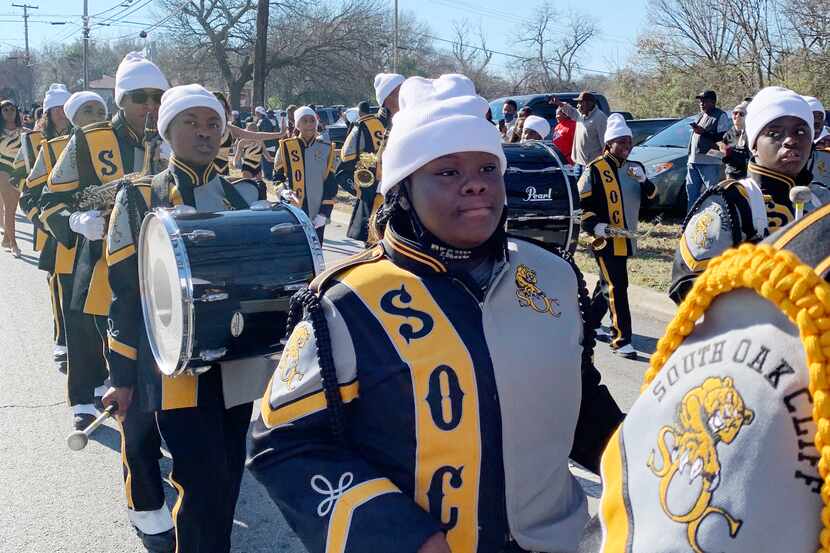 South Oak Cliff High School band members line the streets as Dallas celebrates the campus'...