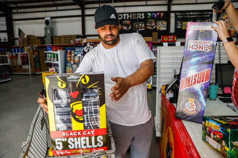 Orlando Ornelas, 39, check out his selection at the cash register at Nelson's Fireworks...