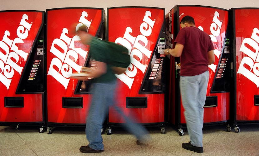 Arlington High students drop their money in the row of Dr. Pepper soft drink vending...