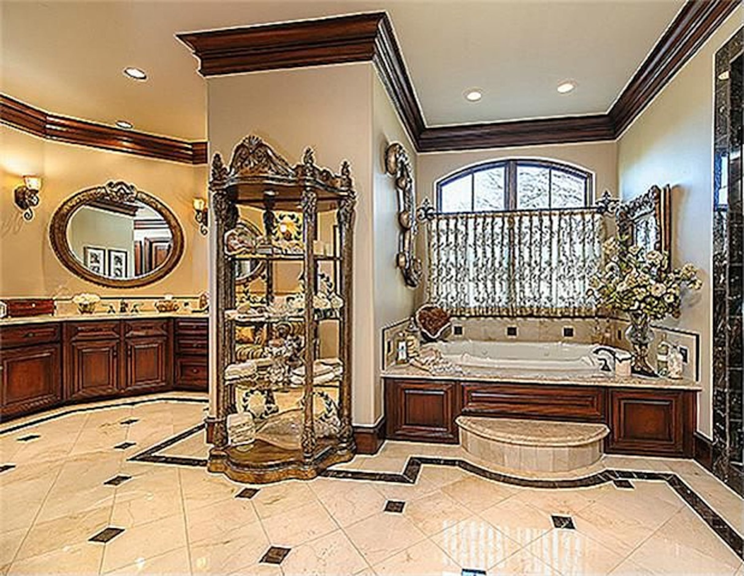 A view of the home's master bathroom, which includes marble, millwork, and hardwood...