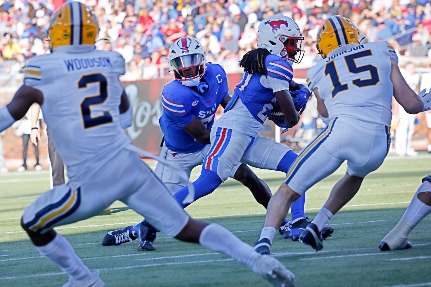 SMU quarterback Kevin Jennings (7) hands off to SMU wide receiver Derrick McFall (20) during...