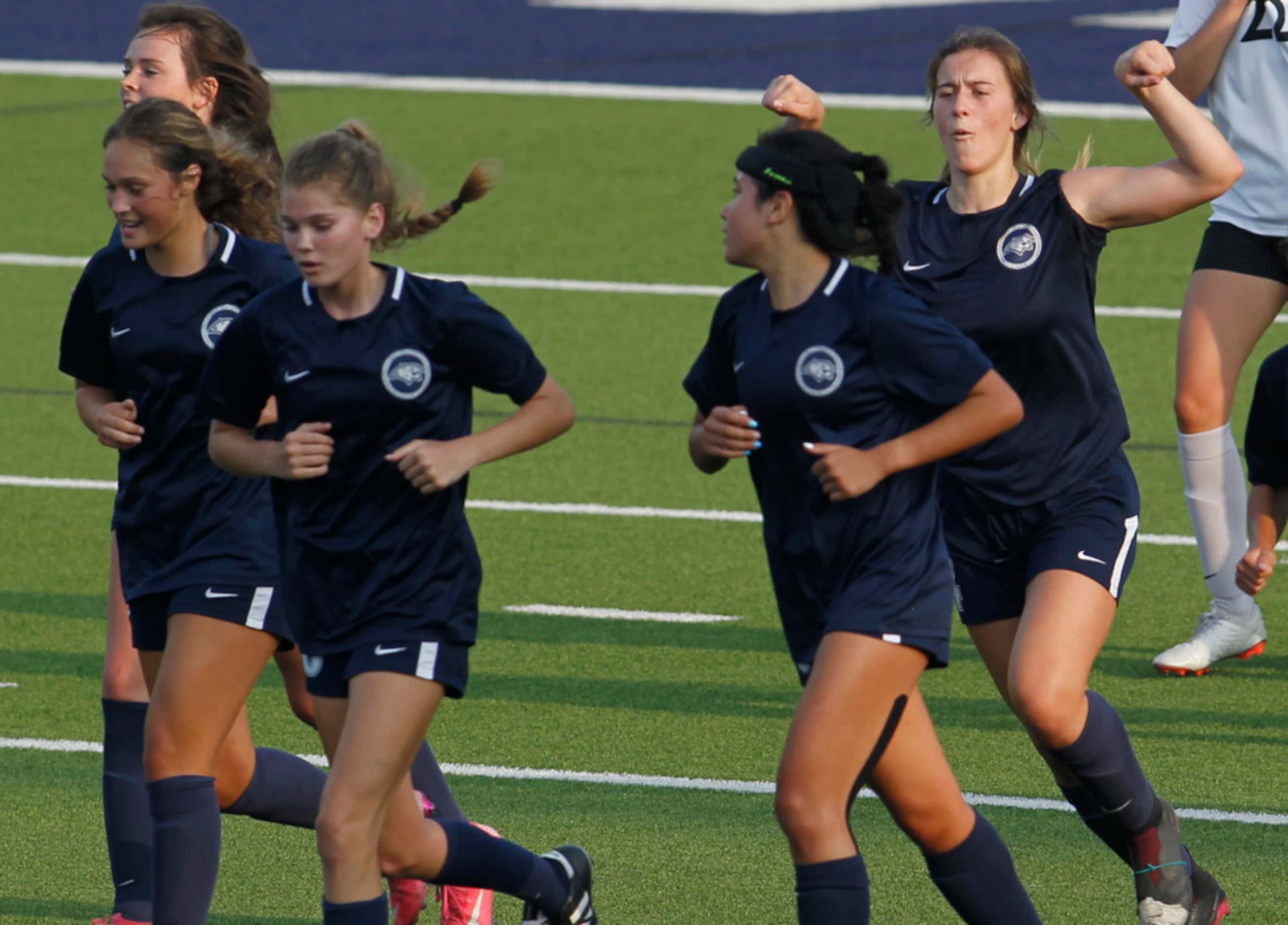 Flower Mound's Marianne Baltmanis (4) flexes her muscles as she responds to the roar of the...