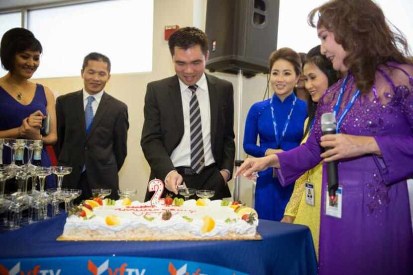 
VIETV staffers and Jennifer Nguyen (right) cut the cake at a celebration of the second...