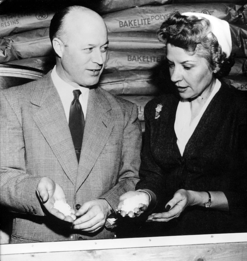 Earl S. Tupper and Brownie Wise hold resin pellets at the Tupperware factory in...