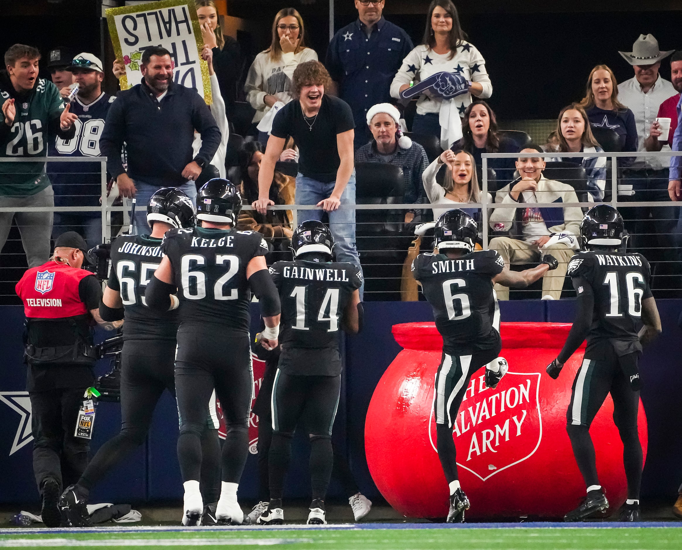 Philadelphia Eagles wide receiver DeVonta Smith (6) kicks a Salvation Army kettle as he...