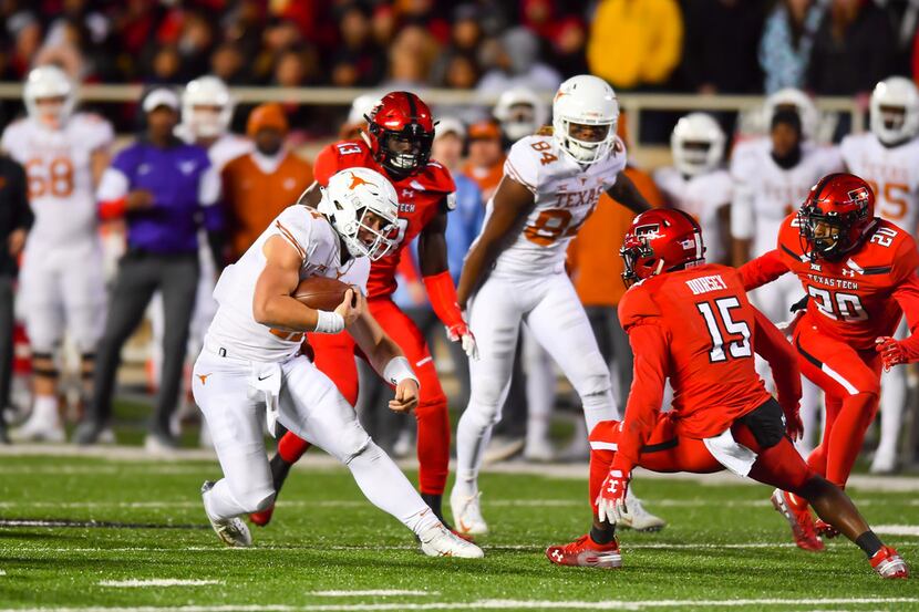 LUBBOCK, TX - NOVEMBER 10: Sam Ehlinger #11 of the Texas Longhorns tries to get around...