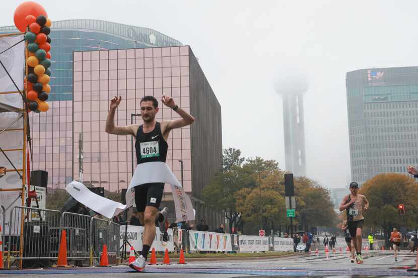 Zachary Beston cross the finish line for the 5K race with a time of 15 minutes and 24...