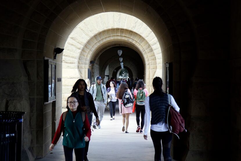 Students walk on campus at Stanford University in Stanford, Calif.  The school admits only 5...