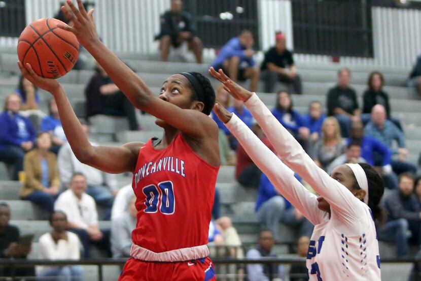 Duncanville guard Zarielle Green (00) keeps her eyes on the prize as she drives to the...