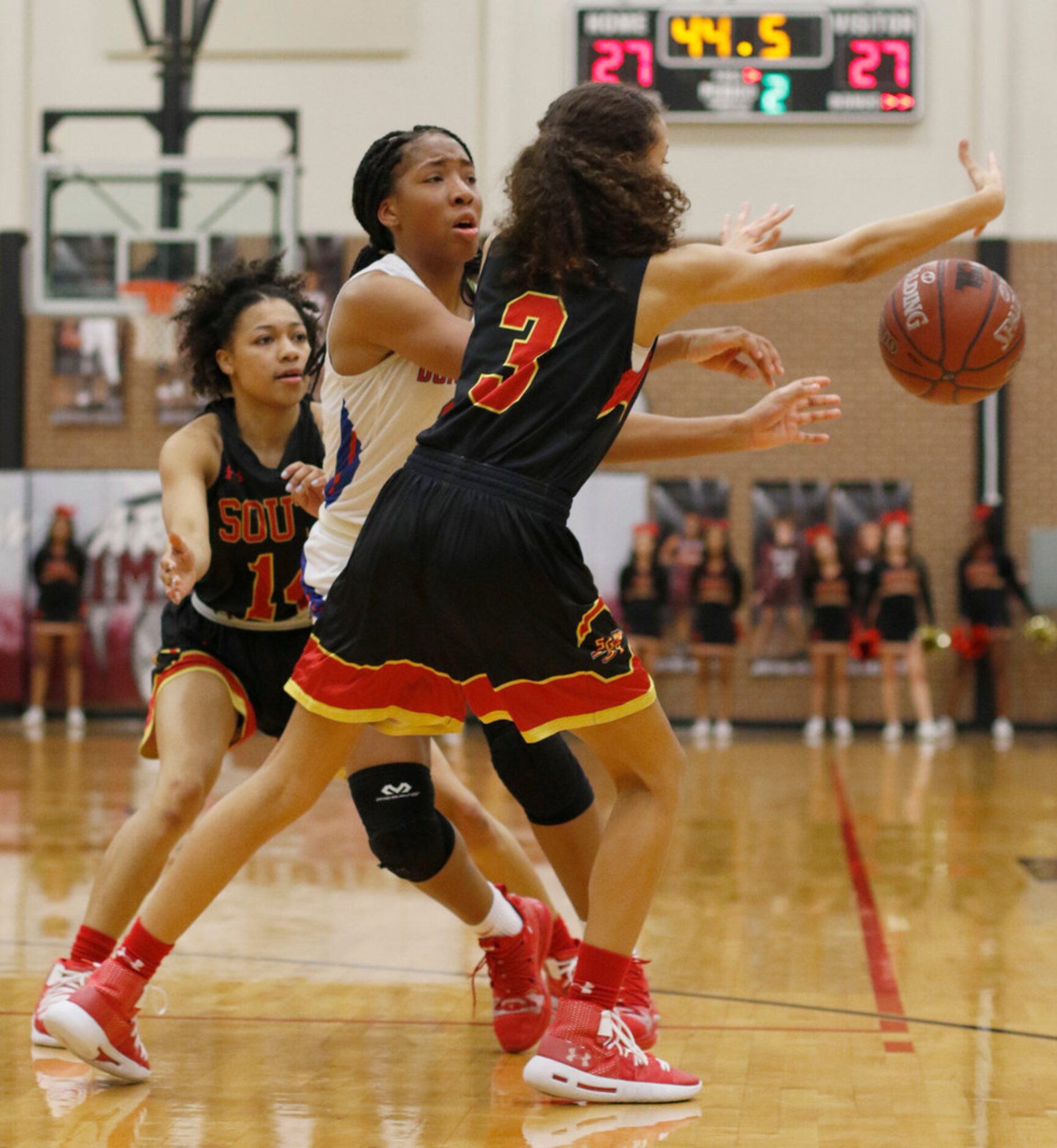 Duncanville guard Nyah Wilson (33) looks to pass to a teammate as she is double teamed by...