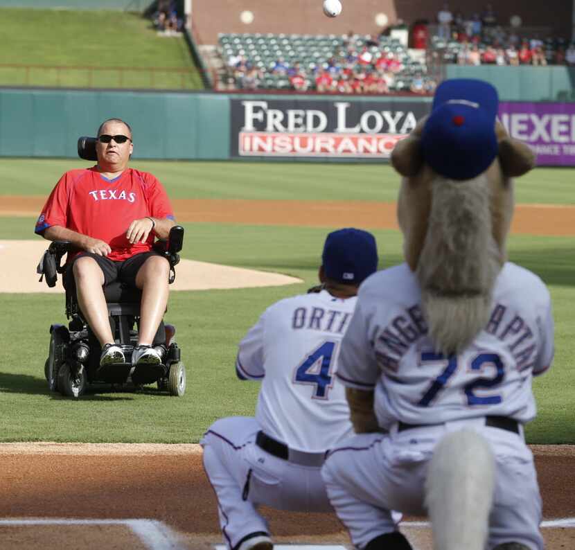 Tracy Beard threw out the ceremonial first pitch before the Texas Rangers-Los Angeles Angels...
