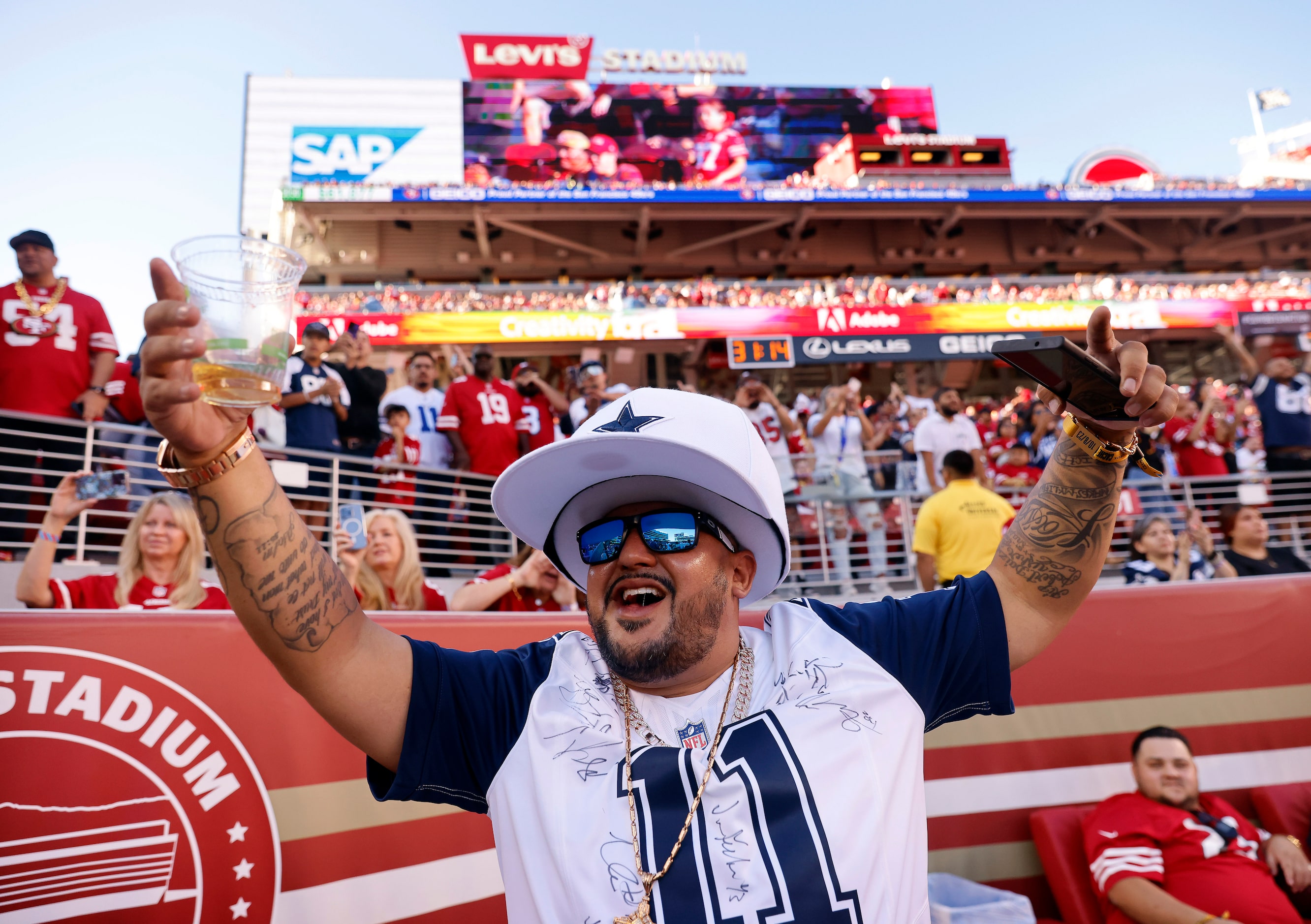 Dallas Cowboys fans cheer as the team finishes pregame warmups before facing the San...