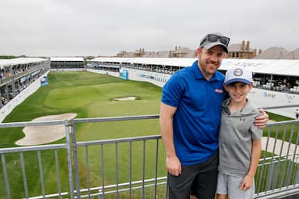 Ryan Pitts stands with his son Noah Pitts, 11, from the stands at the 17th hole during the...
