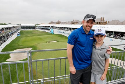 Ryan Pitts stands with his son Noah Pitts, 11, from the stands at the 17th hole during the...