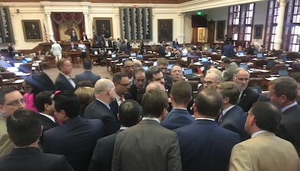 House members huddled at the back of the chamber late Thursday after Rep. Jonathan...