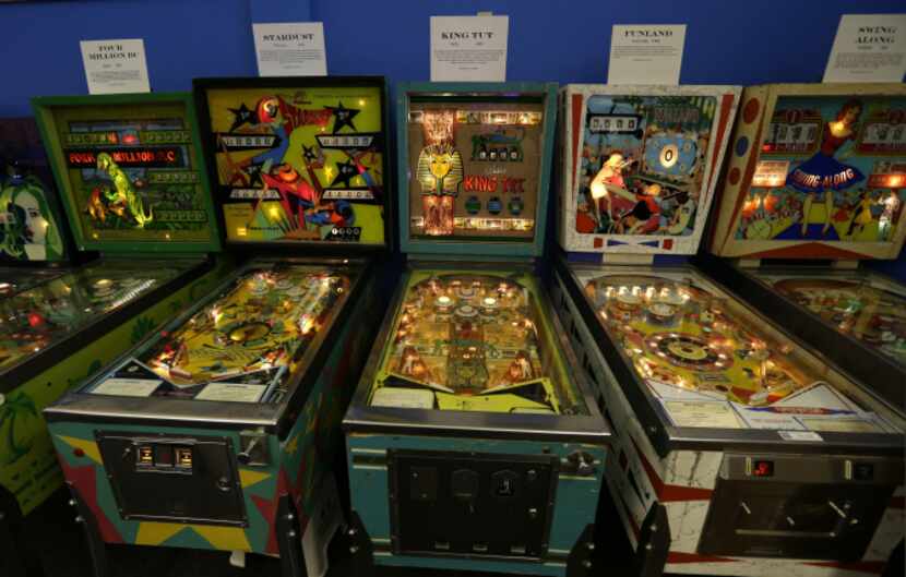 In this Dec. 16, 2013 photo, older pinball machines line a wall of the Seattle Pinball...
