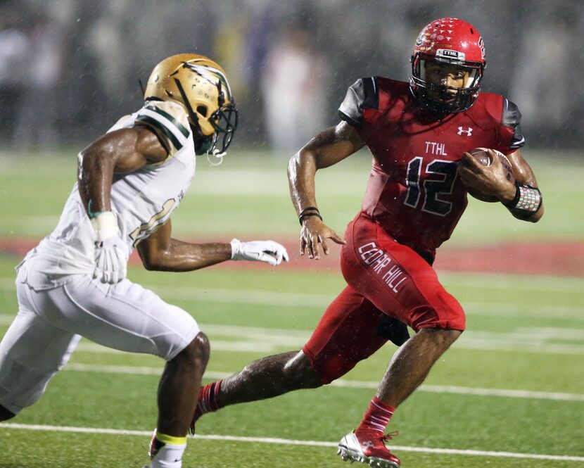 Cedar Hill's Avery Davis (12) attempts to evade DeSoto's KD Nixon (10) during the first half...