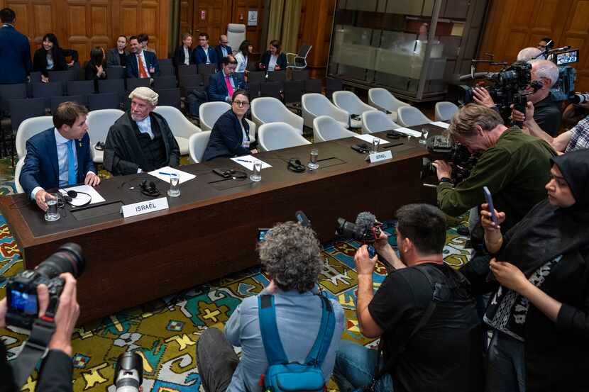 Journalists take images of Israel's legal team, with Yaron Wax, Malcolm Shaw and Avigail...