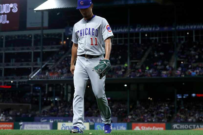 Chicago Cubs starting pitcher Yu Darvish (11) walks to the dugout after being pulled in the...